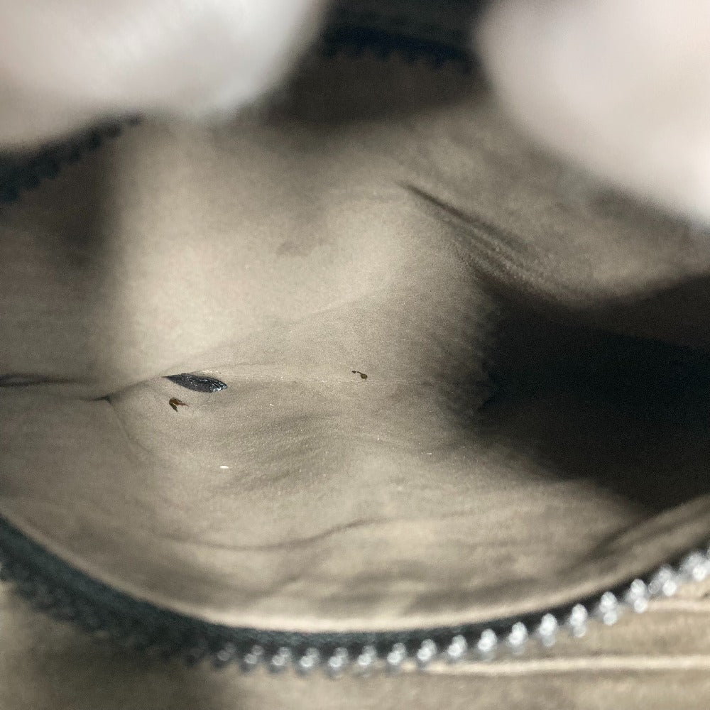 Close-up of a textured surface with a zipper, showing wear and tear.