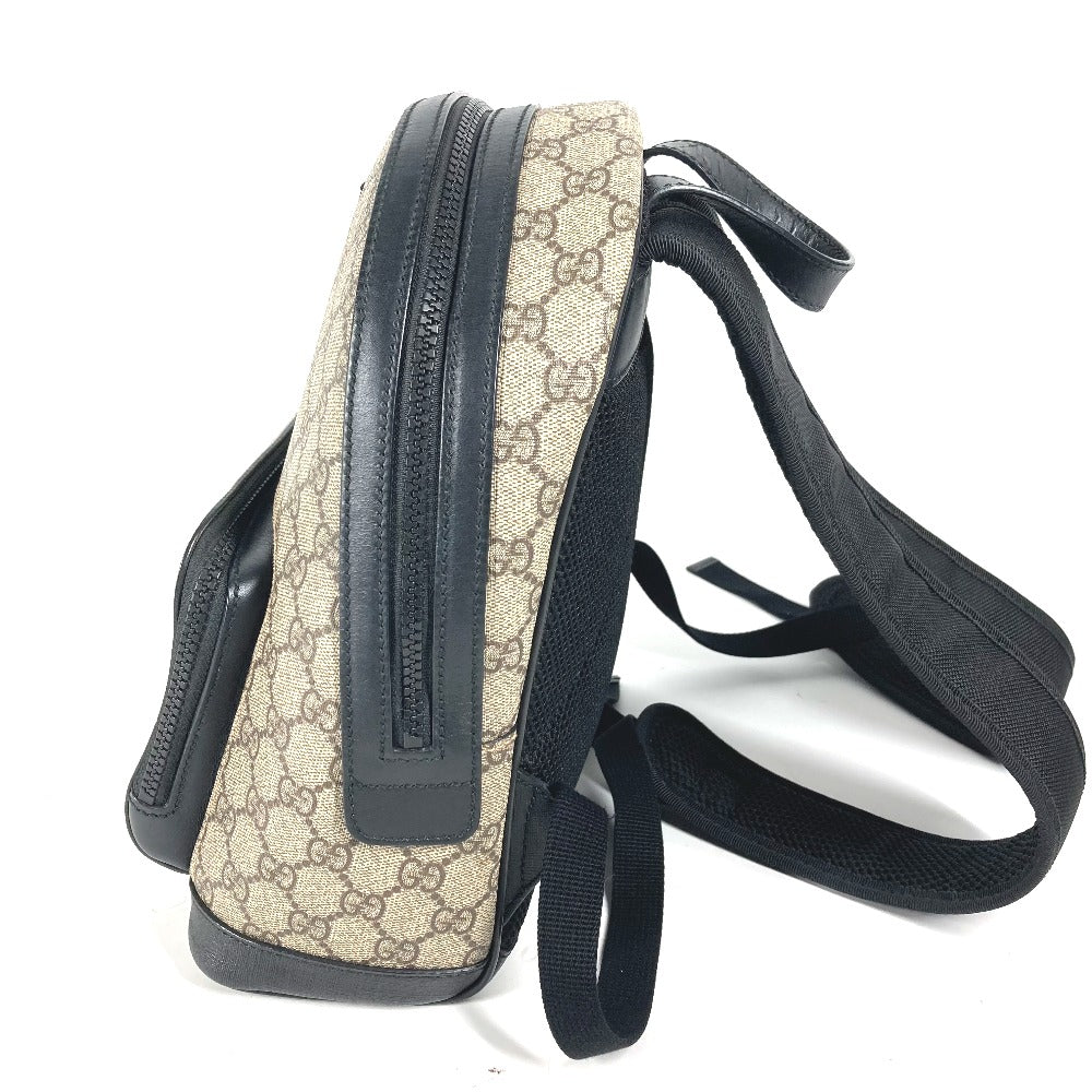 Beige patterned bag with black accents on a white background