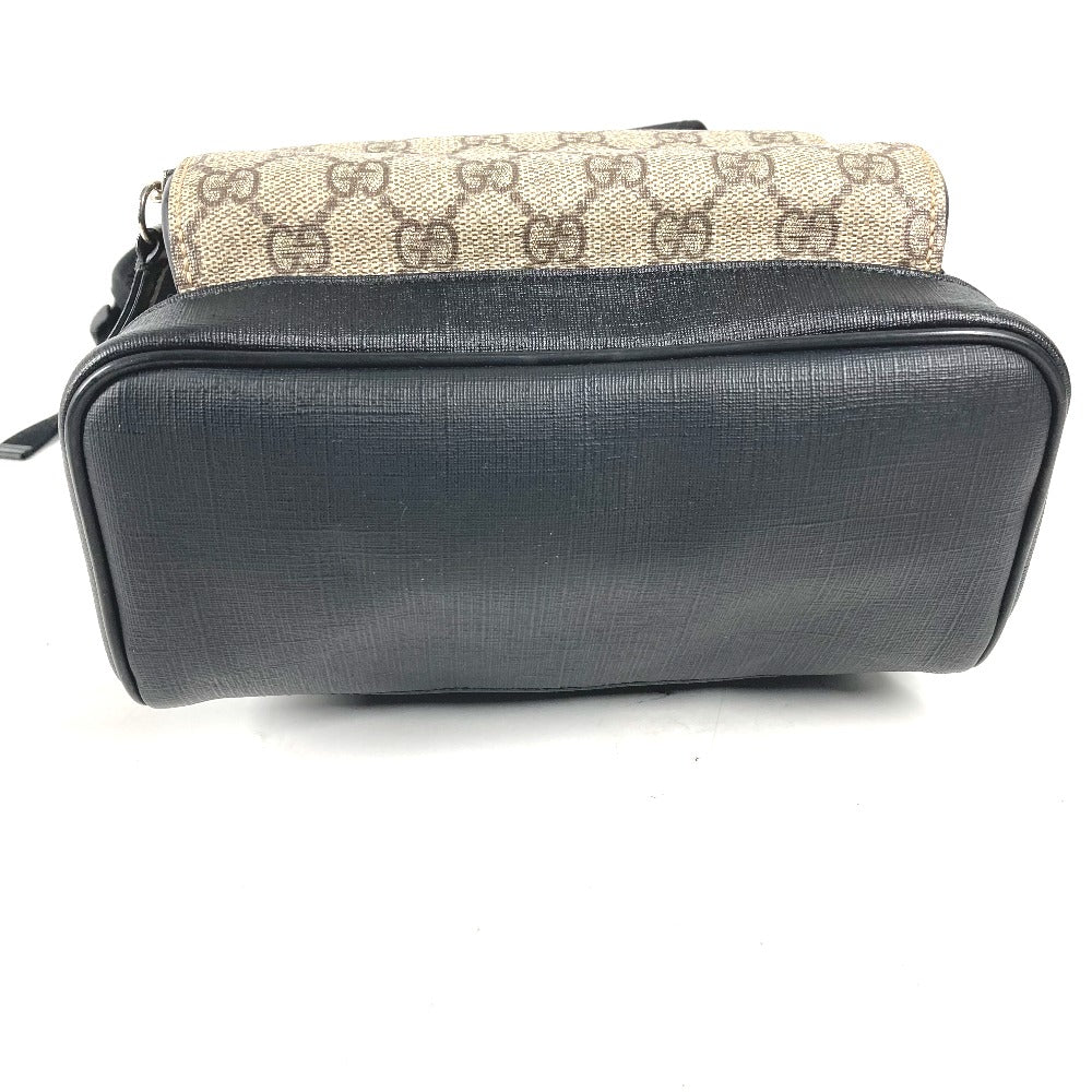 Black and beige handbag with Gucci logo on a white background