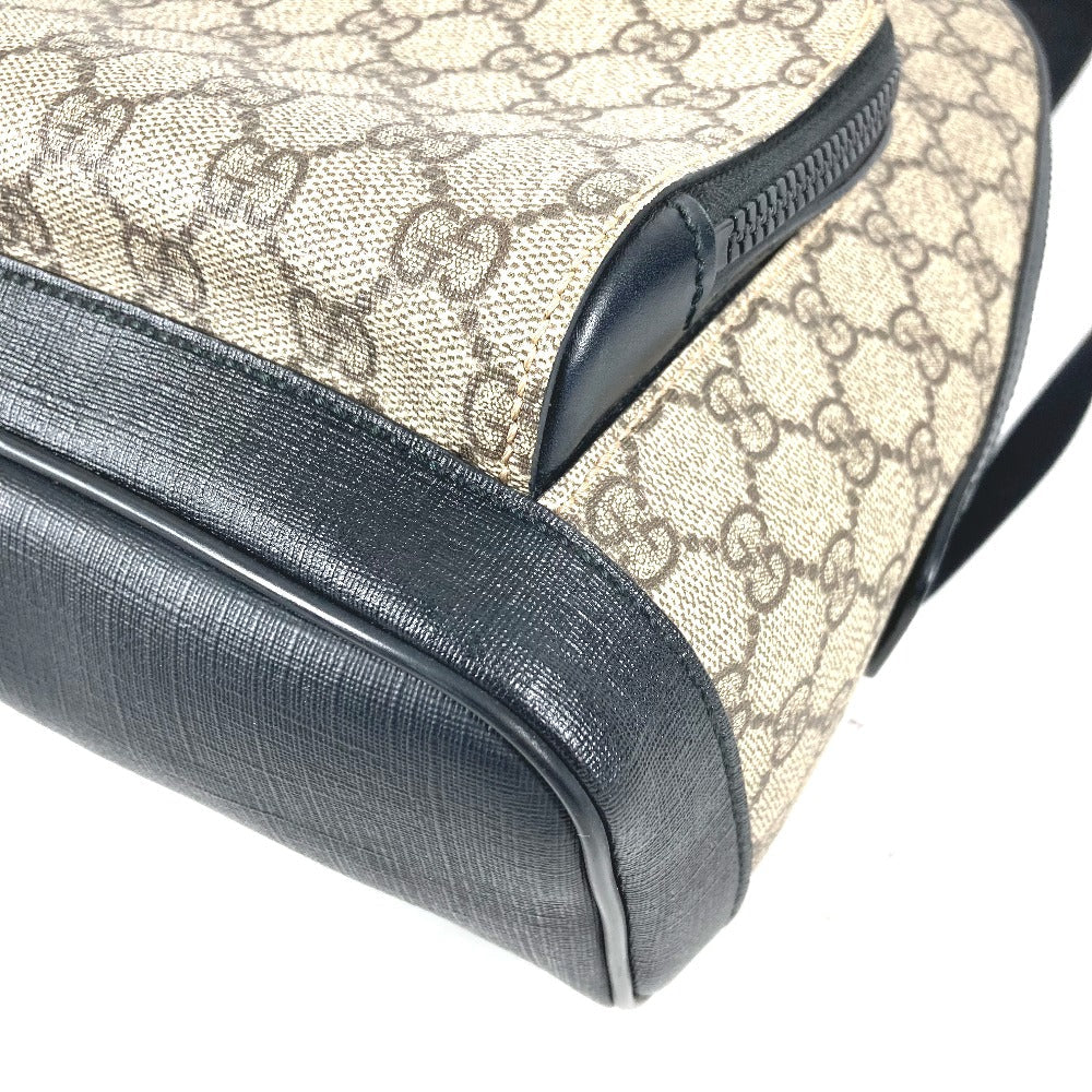 Close-up of a Gucci bag with monogram pattern and black accents.