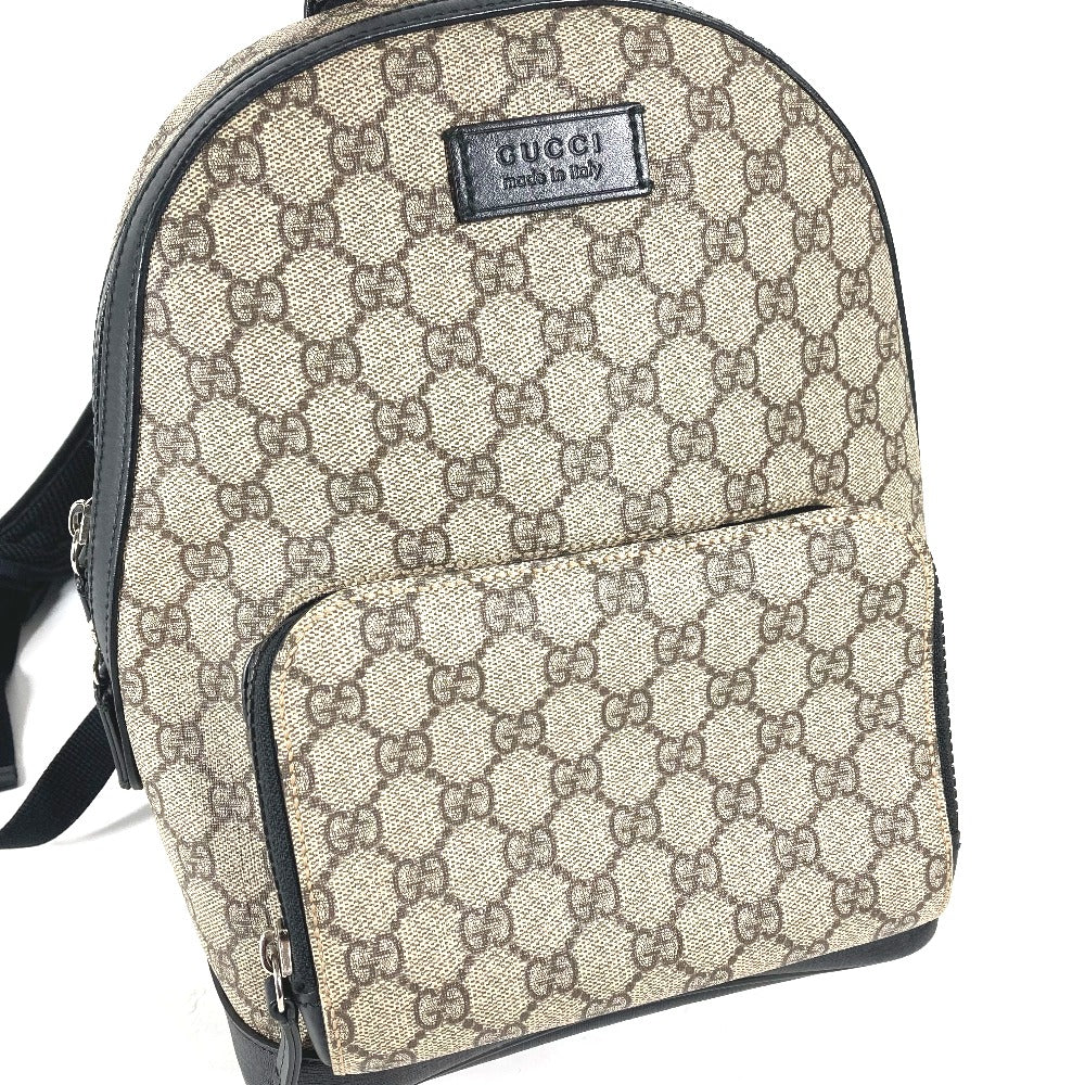 Beige Gucci backpack with monogram pattern on a white background