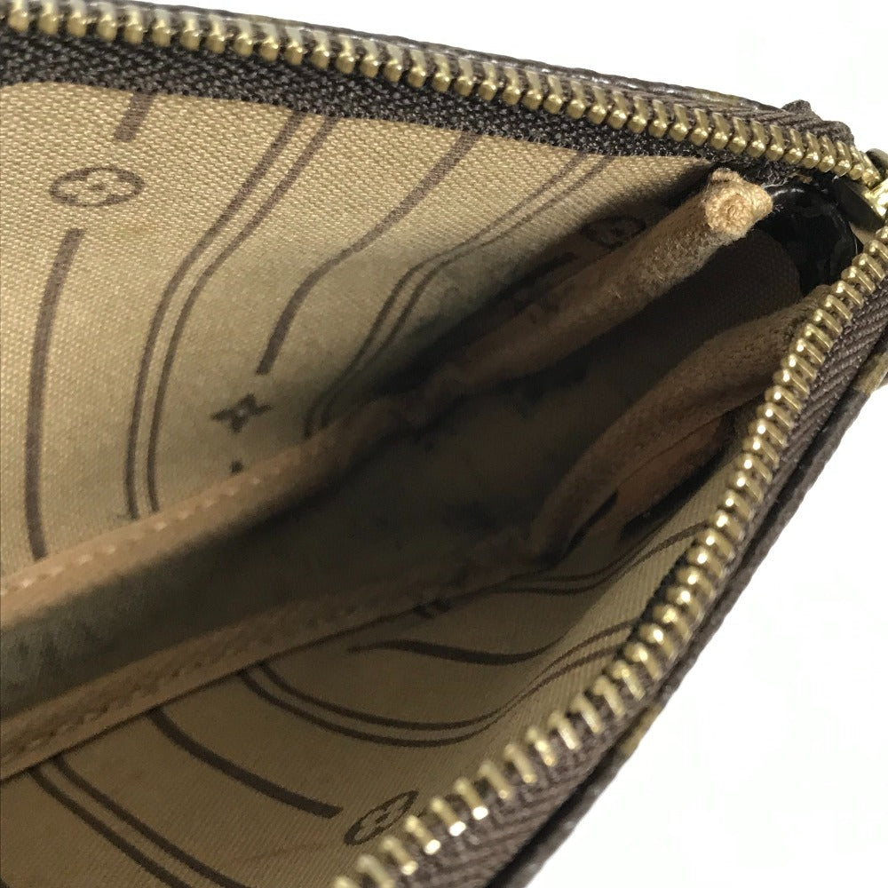 Close-up of a brown leather wallet with gold zipper