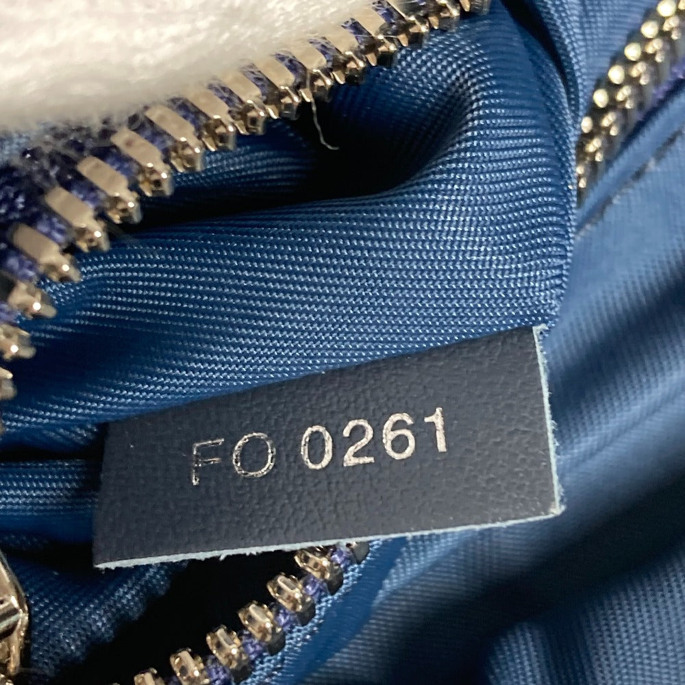Close-up of a blue fabric with a zipper and a label with 'FO 0261' text.