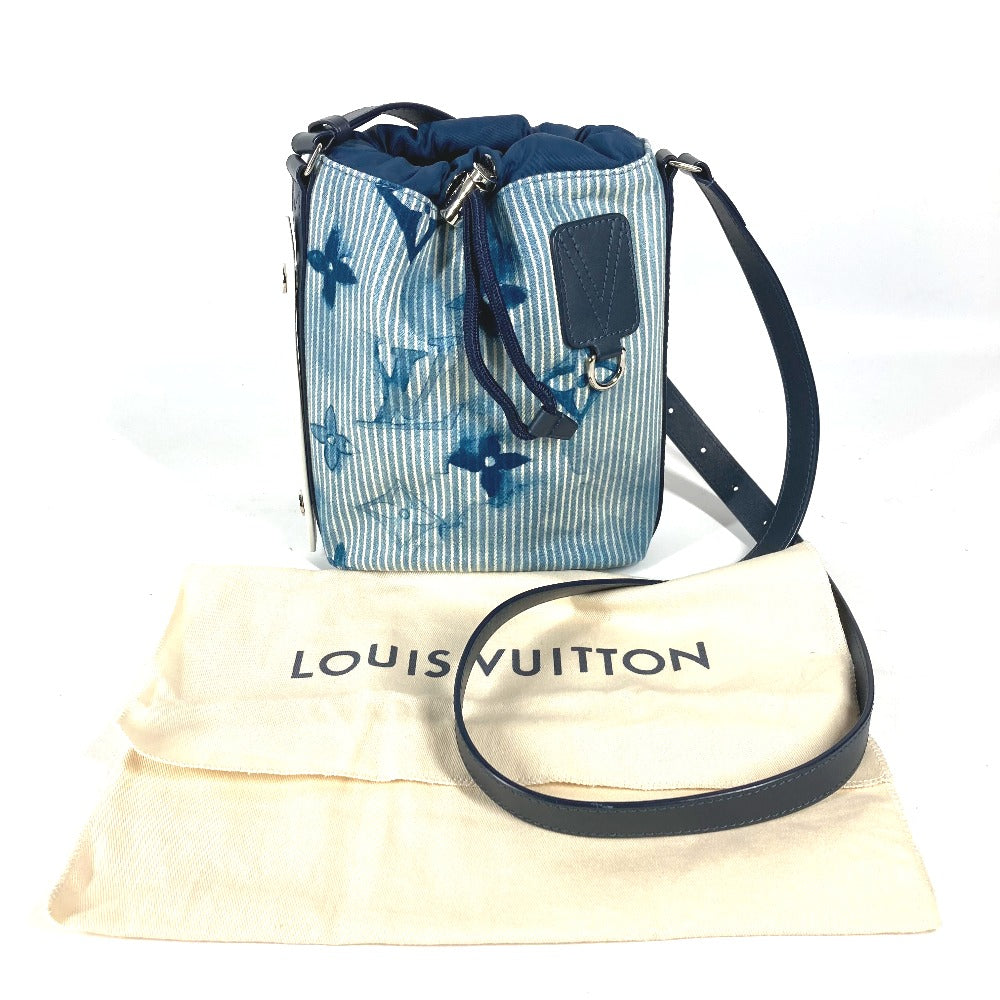 Blue patterned handbag with black strap on a Louis Vuitton dust bag