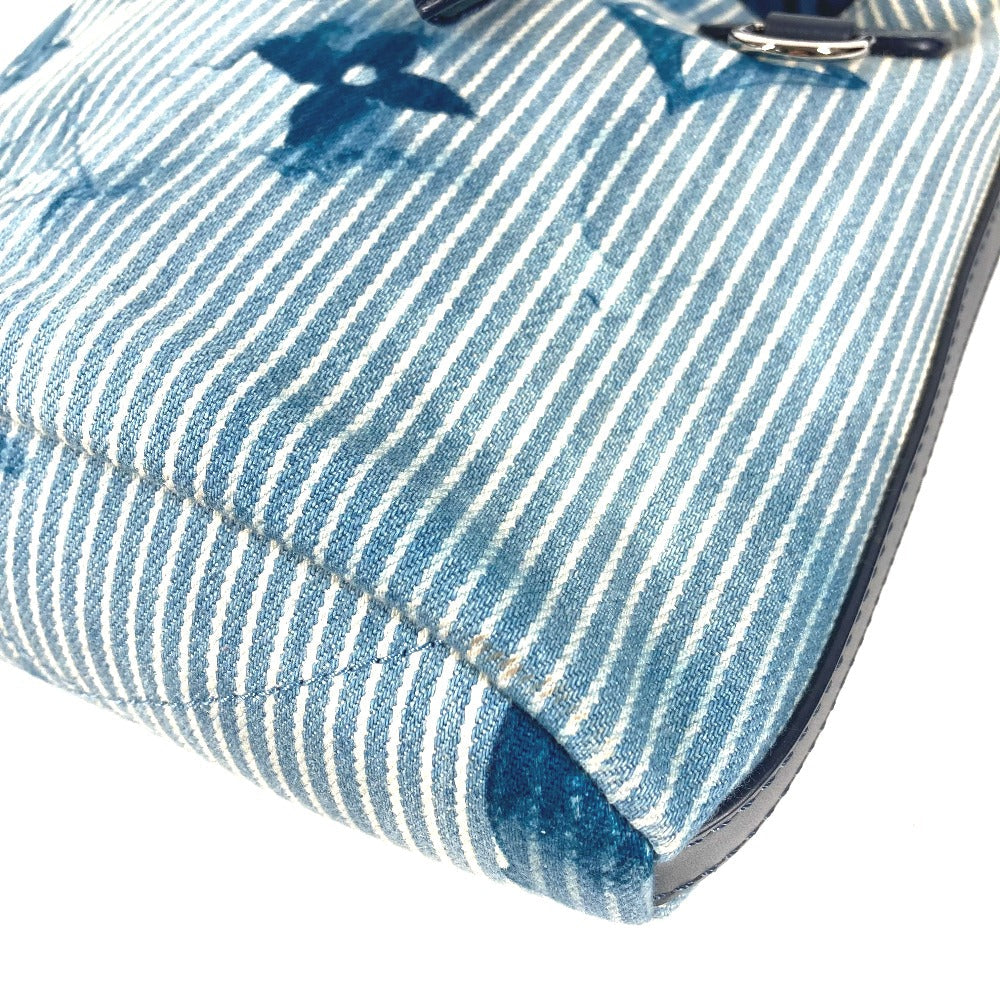 Close-up of a blue and white striped fabric with a butterfly design.