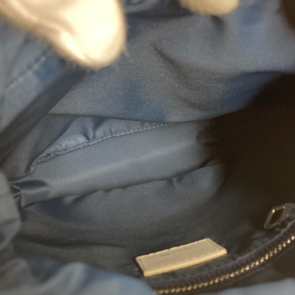 Close-up of a blue textured surface with a gold zipper tab.
