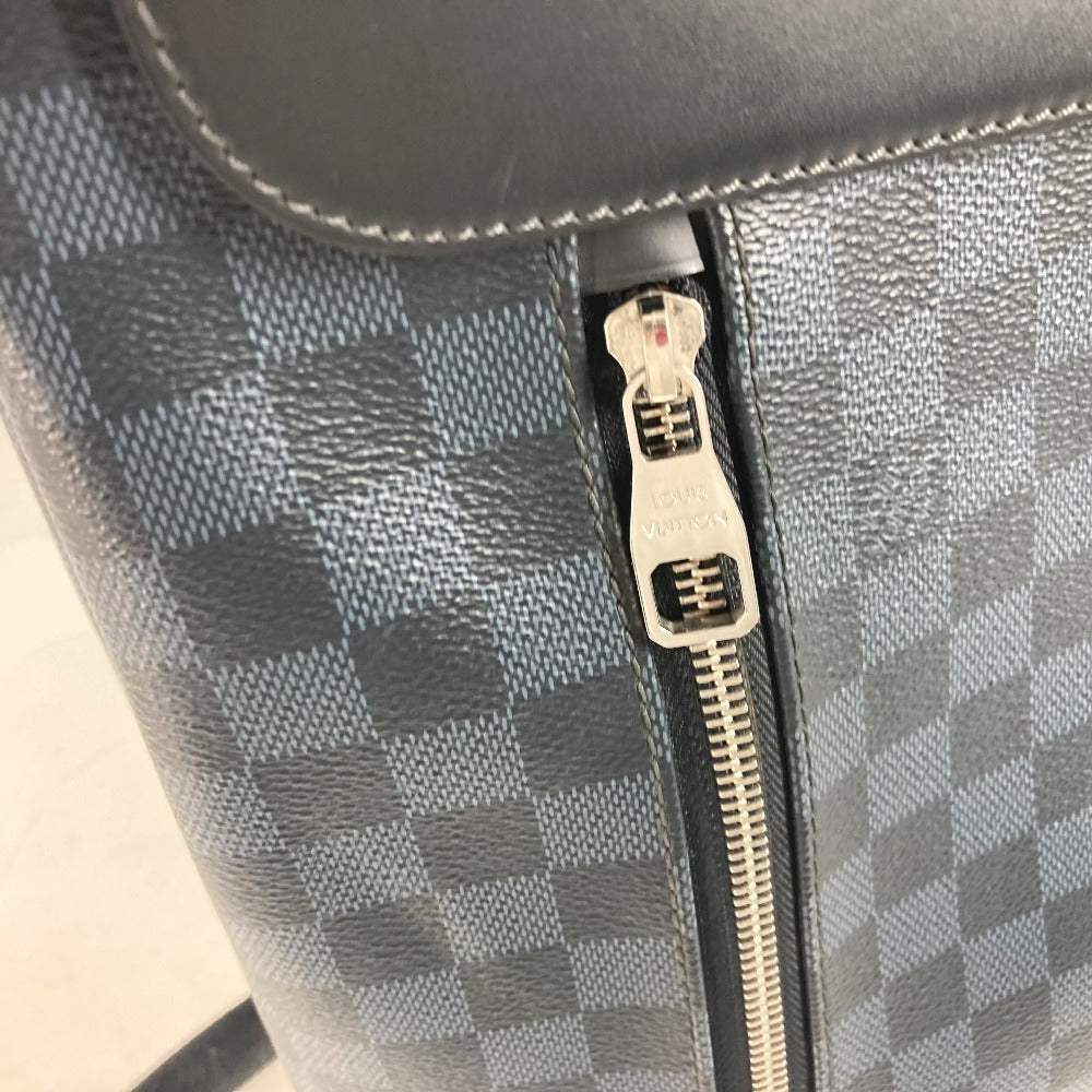 Close-up of a gray checkered bag with a zipper