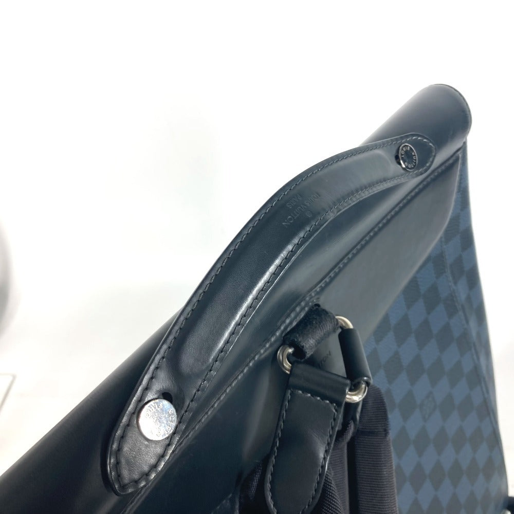 Close-up of a black leather bag with metal hardware on a white background
