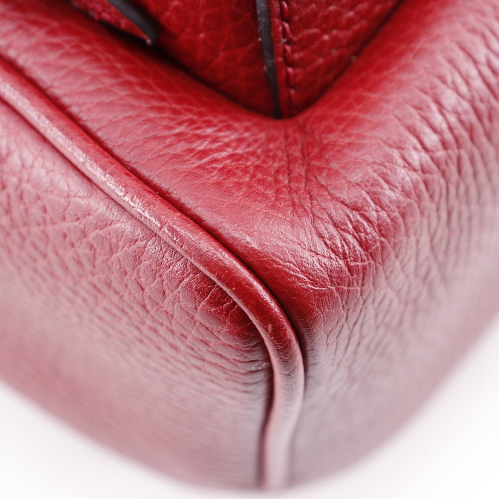 Close-up of a red leather glove on a white background