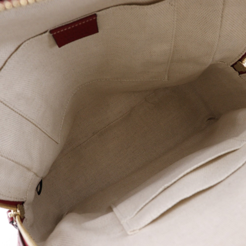 Close-up of a beige fabric interior with a brown leather patch.