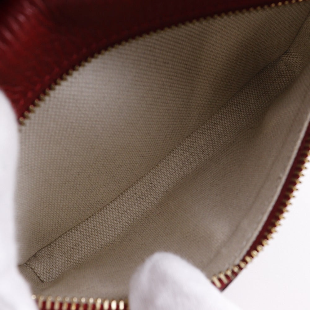 Close-up of a textured fabric interior with a zipper, likely from a bag or pouch.
