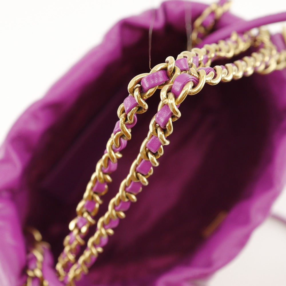Gold and purple beaded bracelet on a purple fabric background