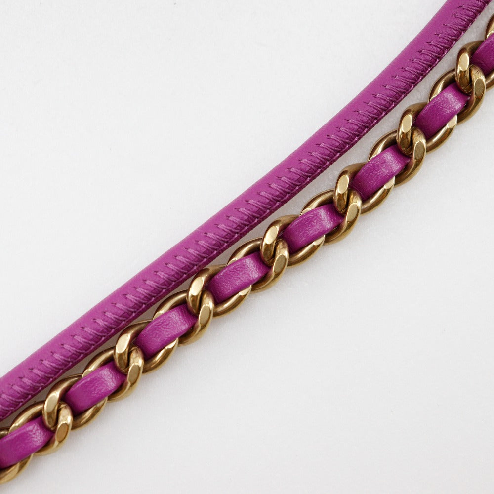 Purple belt with gold chain detail on a white background