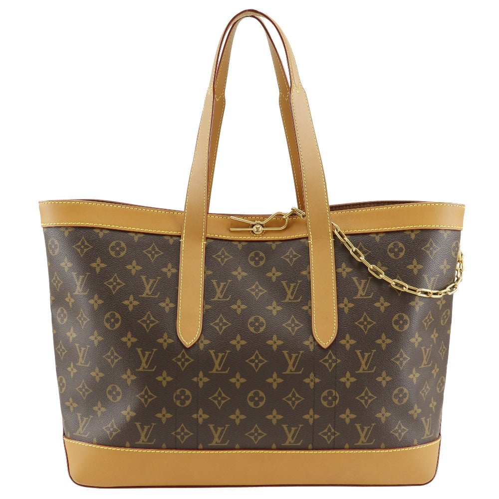 Designer handbag with monogram pattern and gold accents on a white background