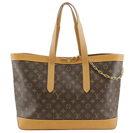 Designer handbag with monogram pattern and gold accents on a white background