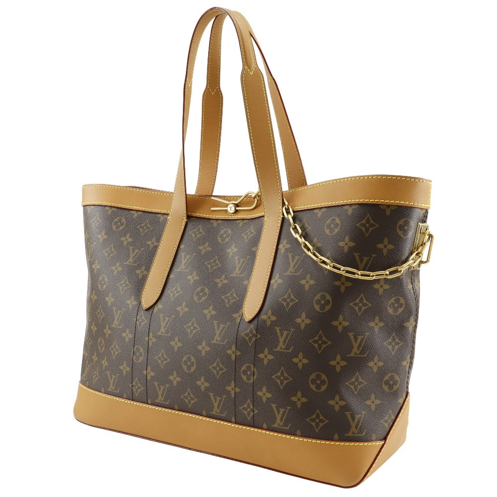 Designer handbag with monogram pattern and tan accents on a white background