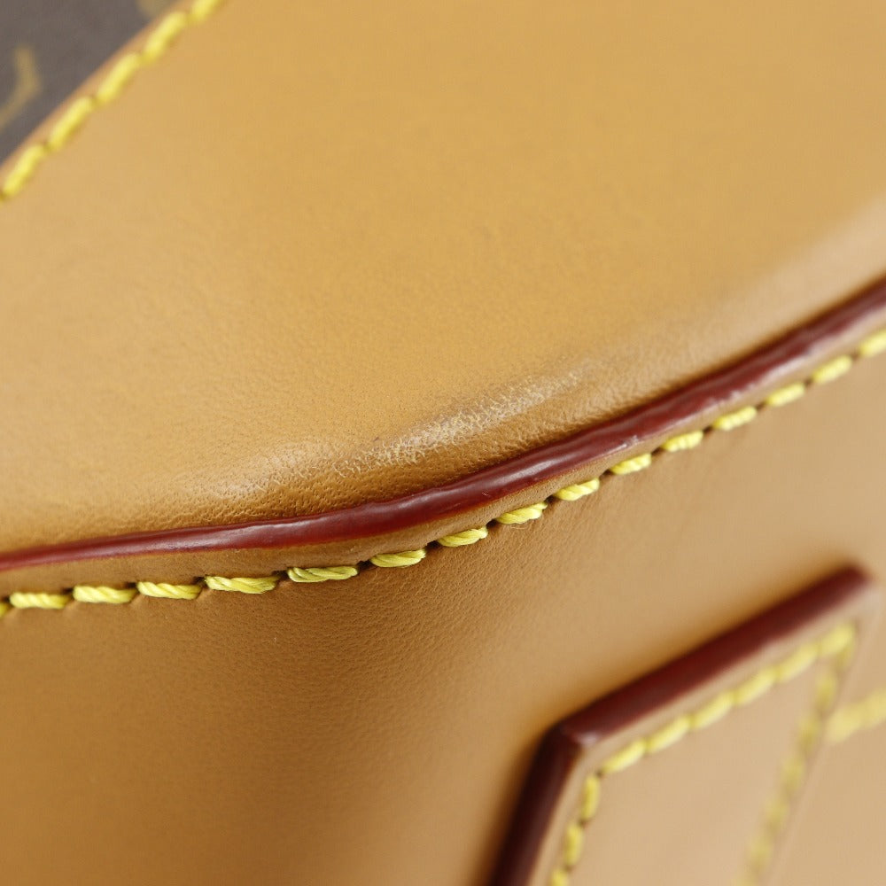 Close-up of brown leather with yellow stitching