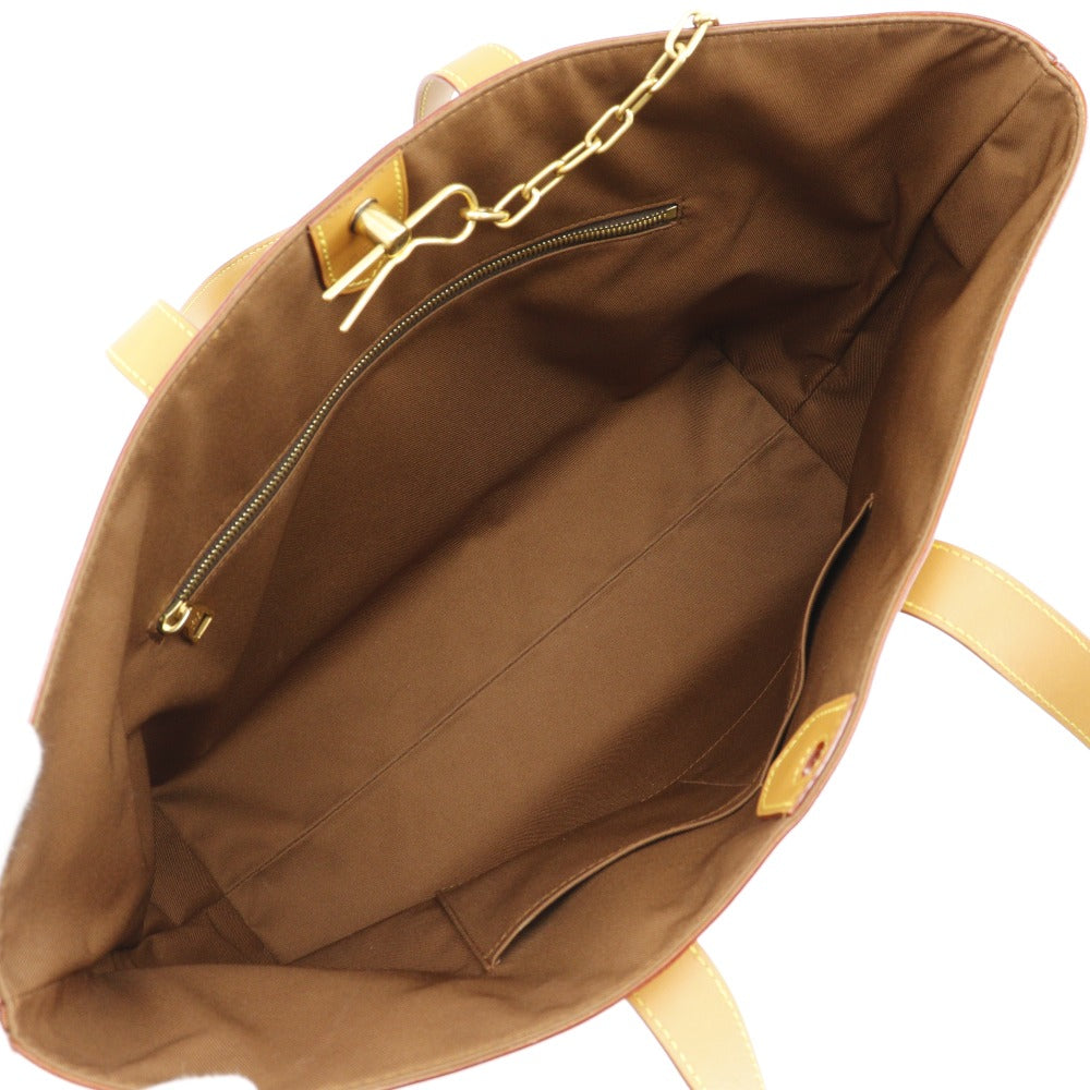 Brown bag with gold chain and handle on a white background