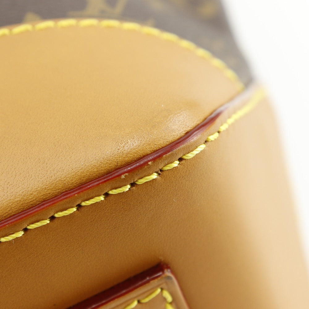 Close-up of a brown leather product with yellow stitching