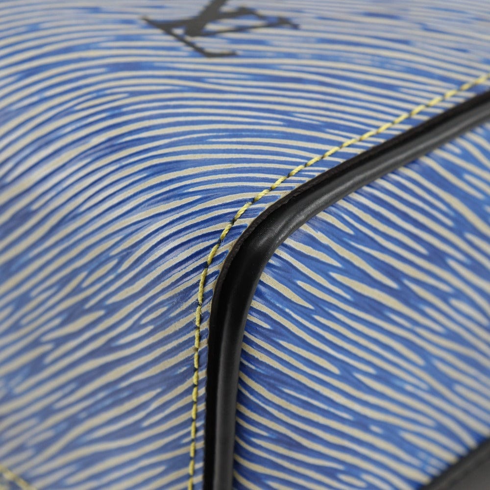 Close-up of a blue and white striped fabric with a black handle.