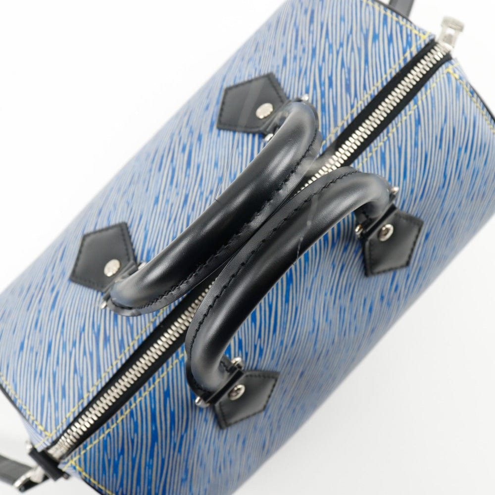 Blue textured suitcase with black handles on a white background