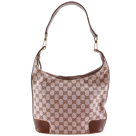 Designer handbag with patterned fabric and brown accents on a white background
