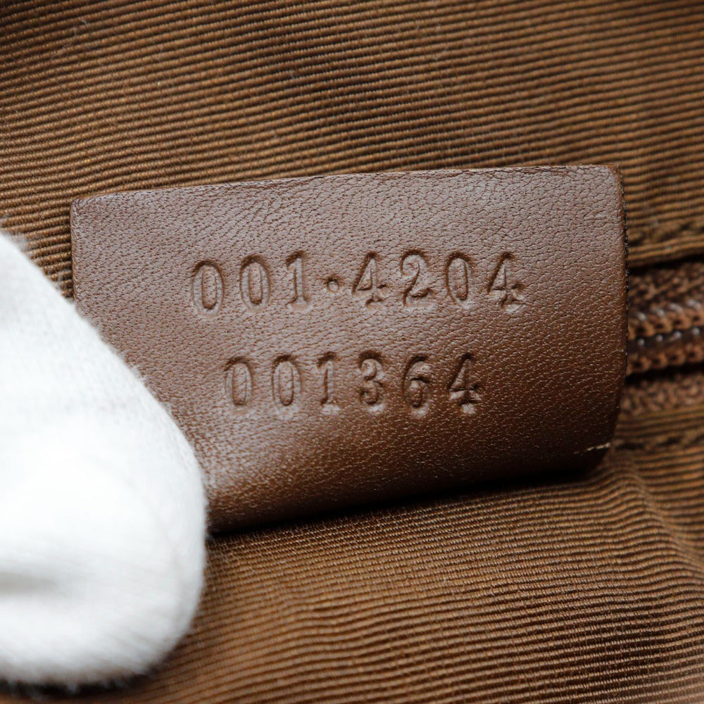 Close-up of a brown leather label with embossed numbers on a textured surface.