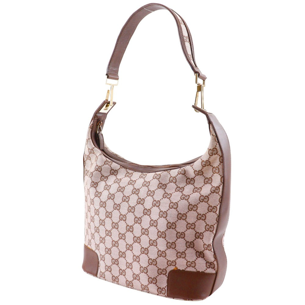Designer handbag with brown and beige pattern on a white background