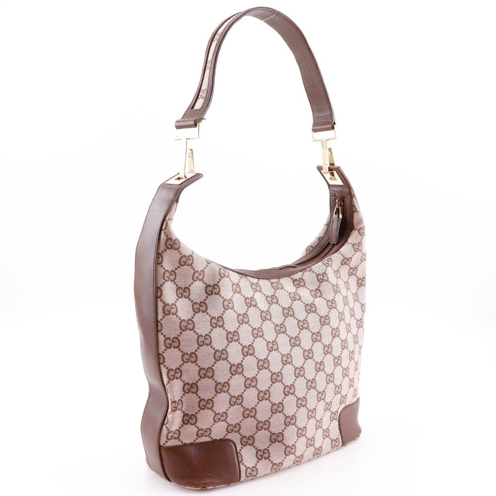 Designer handbag with brown and beige pattern on a white background