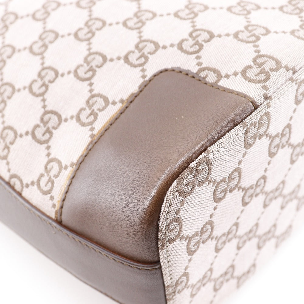 Close-up of a product with a patterned cover and brown leather section.
