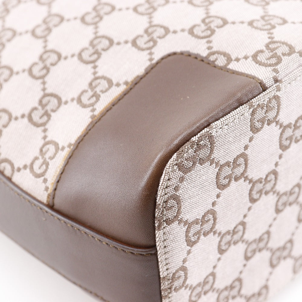 Close-up of a product with a patterned fabric and brown leather accent.