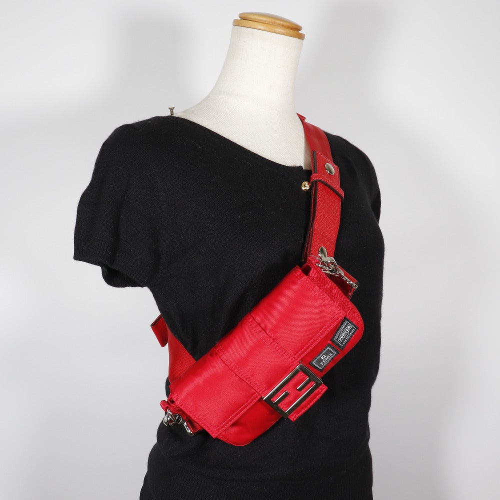Red bag worn by a mannequin against a white background