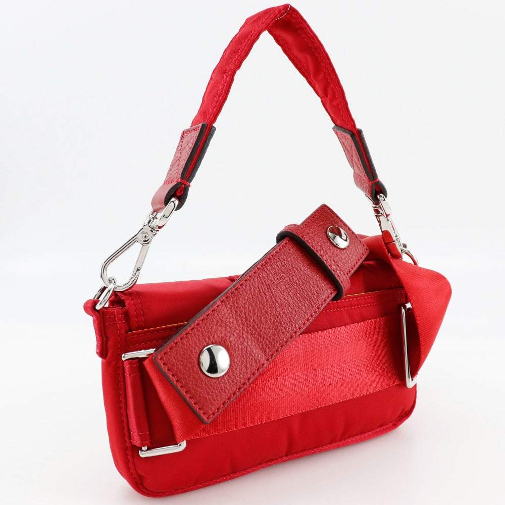 Red handbag with a strap on a white background