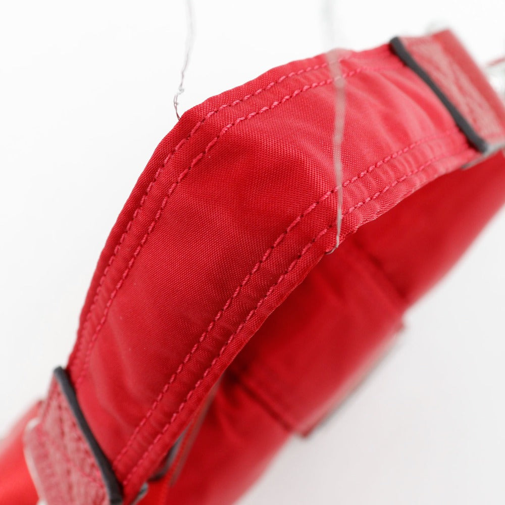 Close-up of a red fabric with stitching detail on a white background
