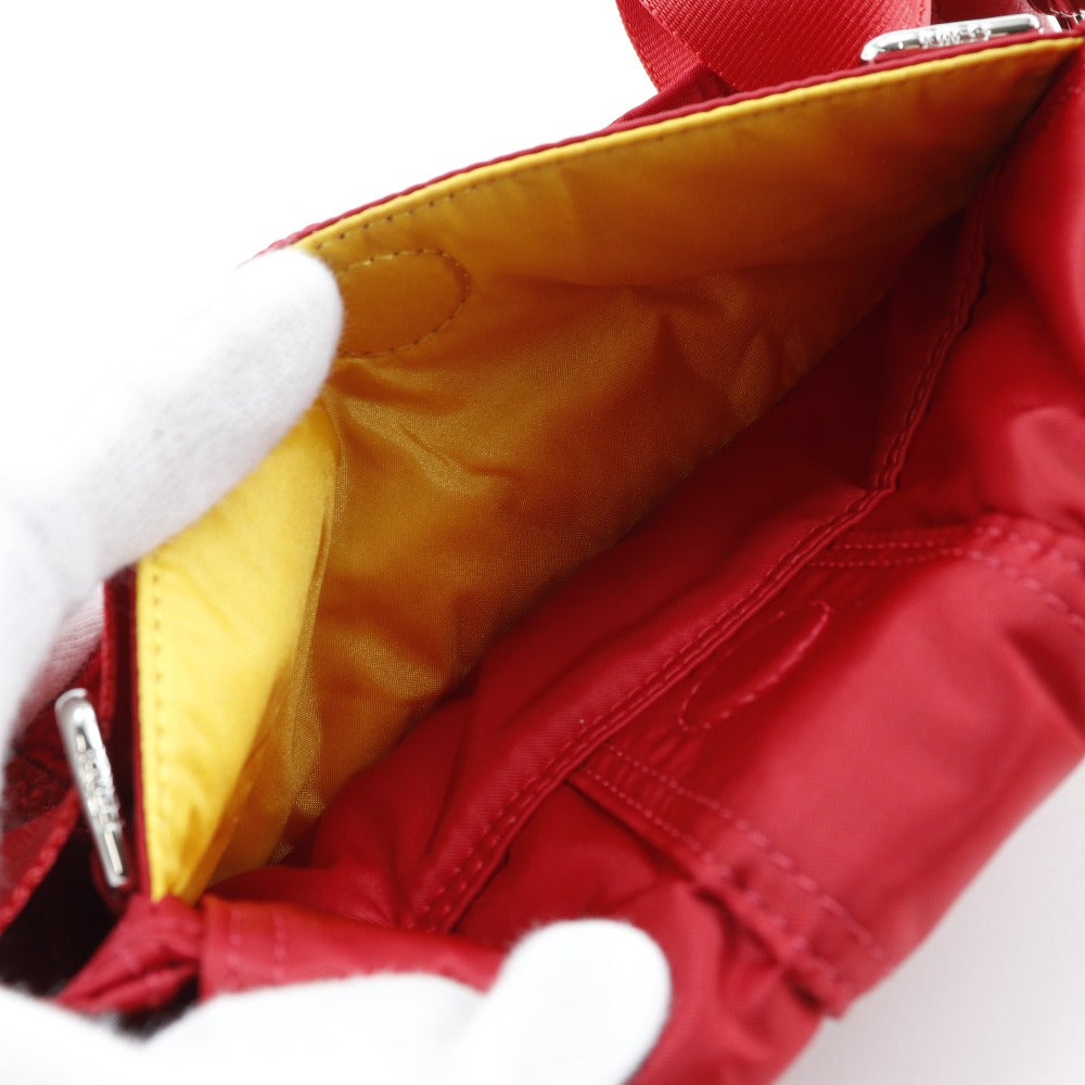 Close-up of a red bag with a yellow interior on a white background