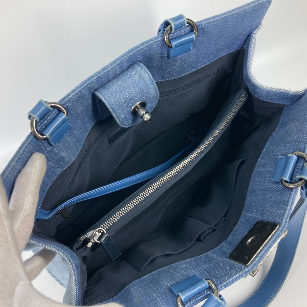 Blue handbag with a zipper on a light gray background