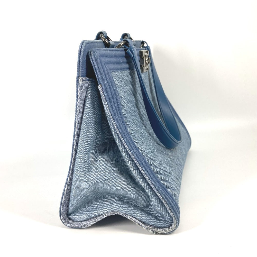 Blue denim pouch with a strap on a white background