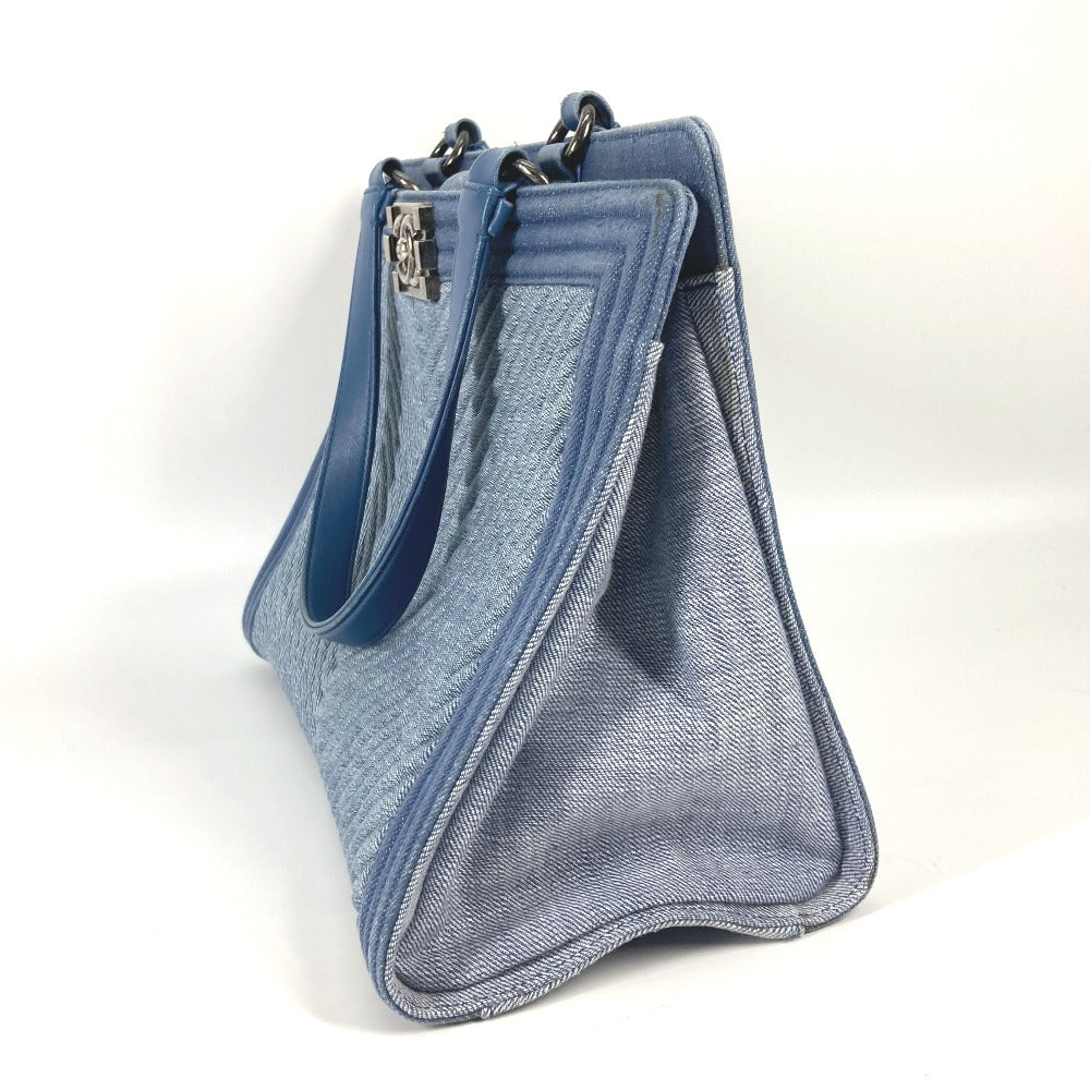 Blue denim handbag with a zipper on a white background