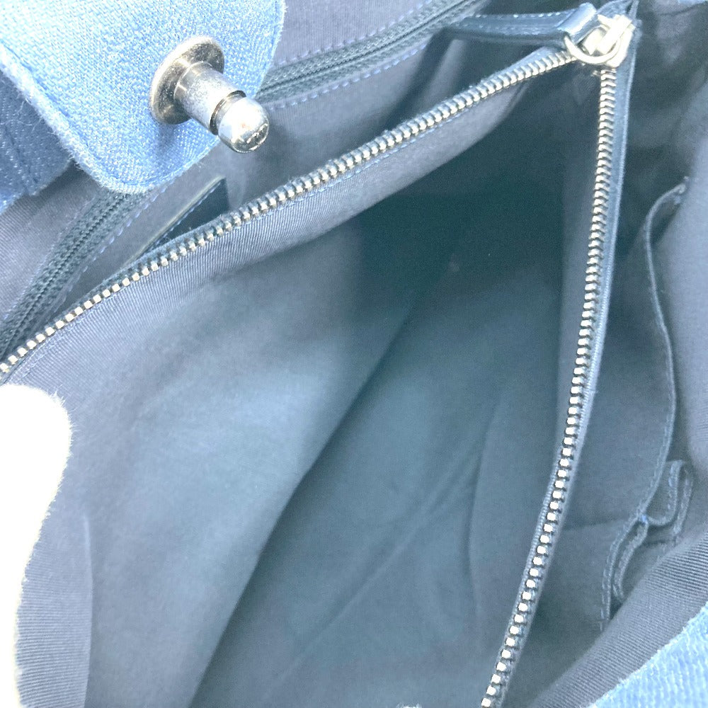 Close-up of a light blue fabric with a zipper and button