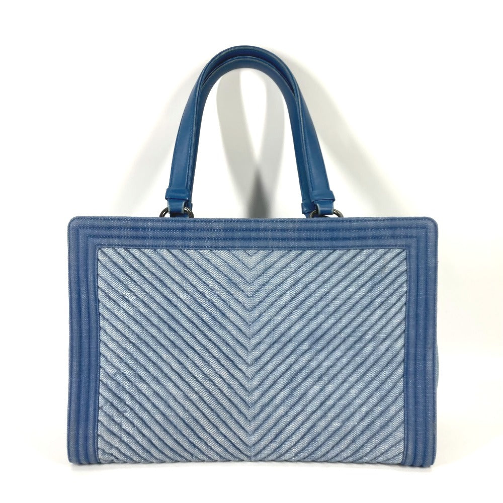Blue handbag with a chevron pattern on a white background