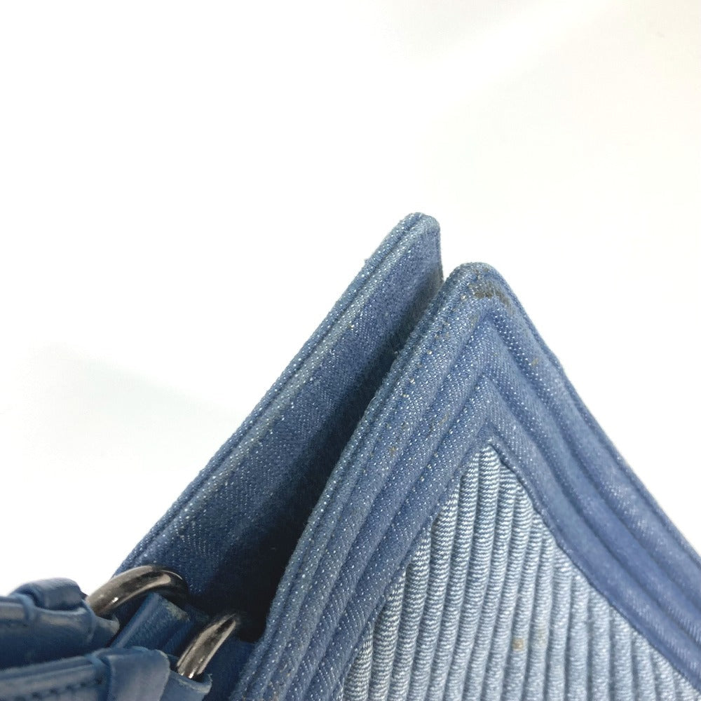 Close-up of a blue textured wallet with a metallic clasp on a white background