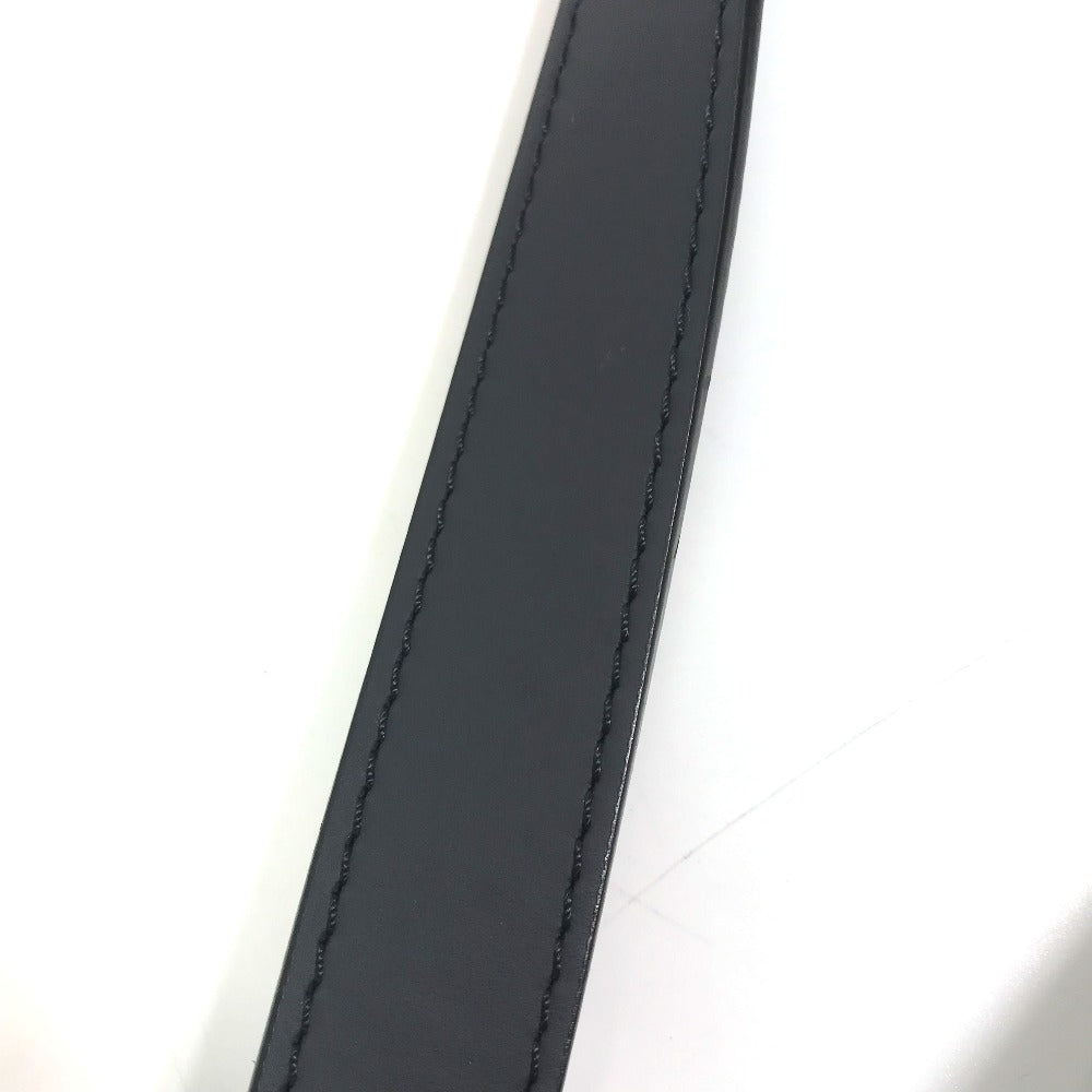 Close-up of a black leather strap on a white background