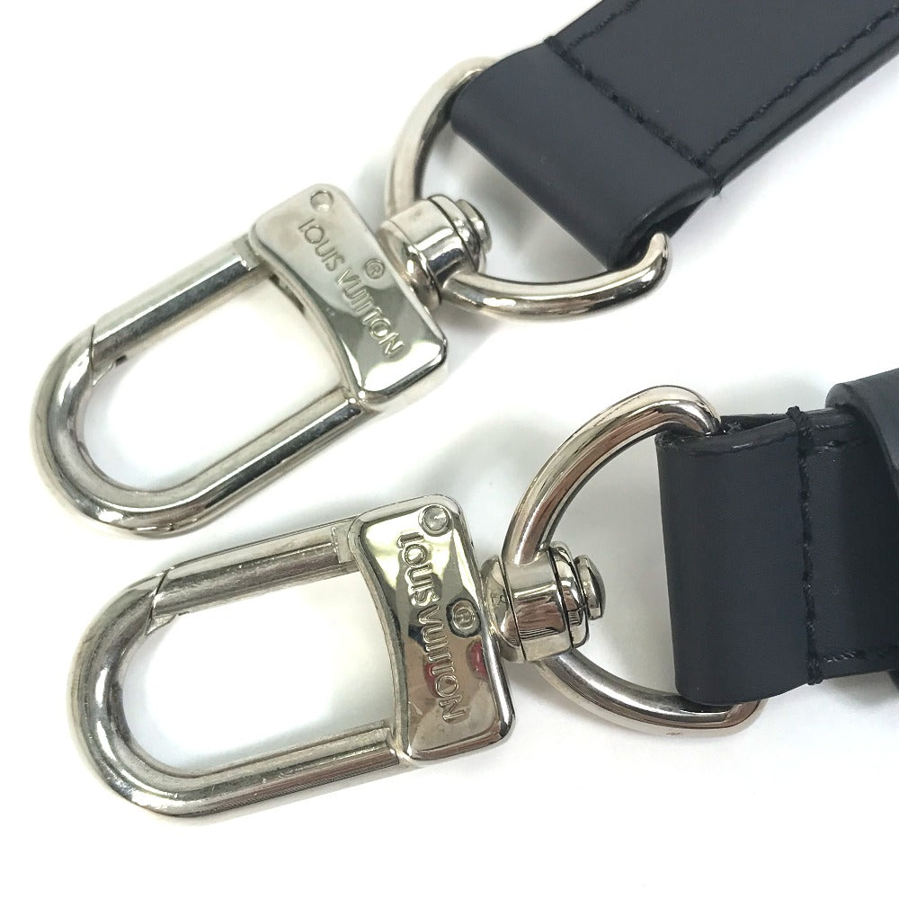 Two silver carabiners attached to black leather straps on a white background