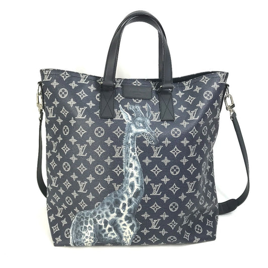 Designer handbag with monogram pattern and giraffe design on a white background