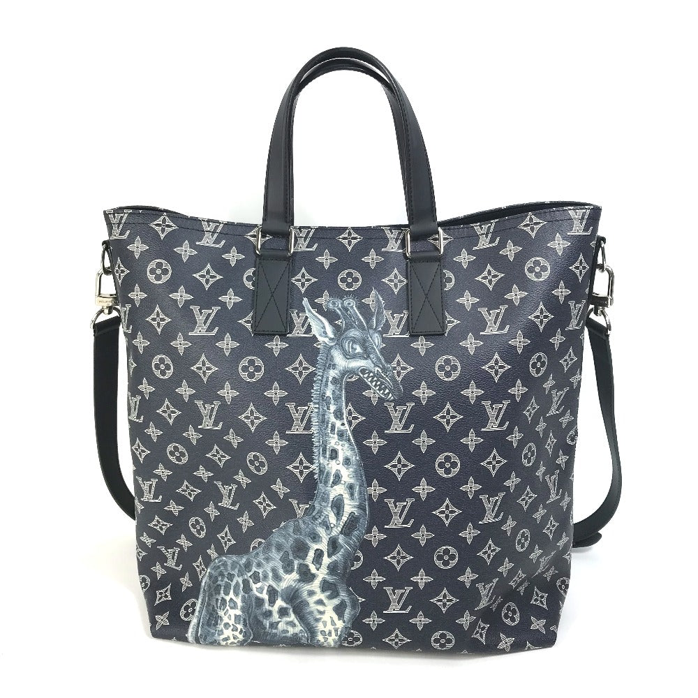 Designer handbag with monogram pattern and giraffe design on a white background