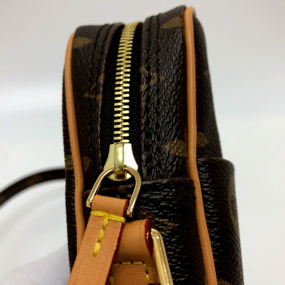 Close-up of a brown leather handbag with gold zipper and trim on a white background