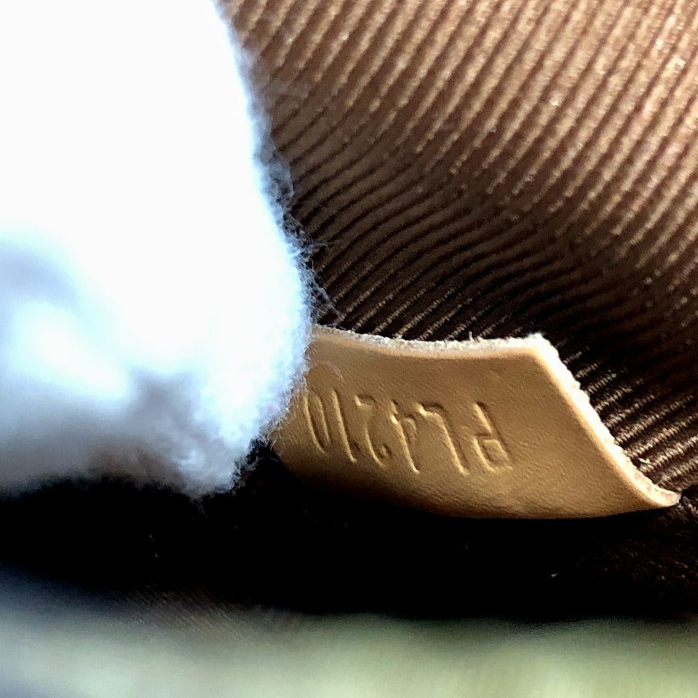 Close-up of a brown fabric with a visible brand label.