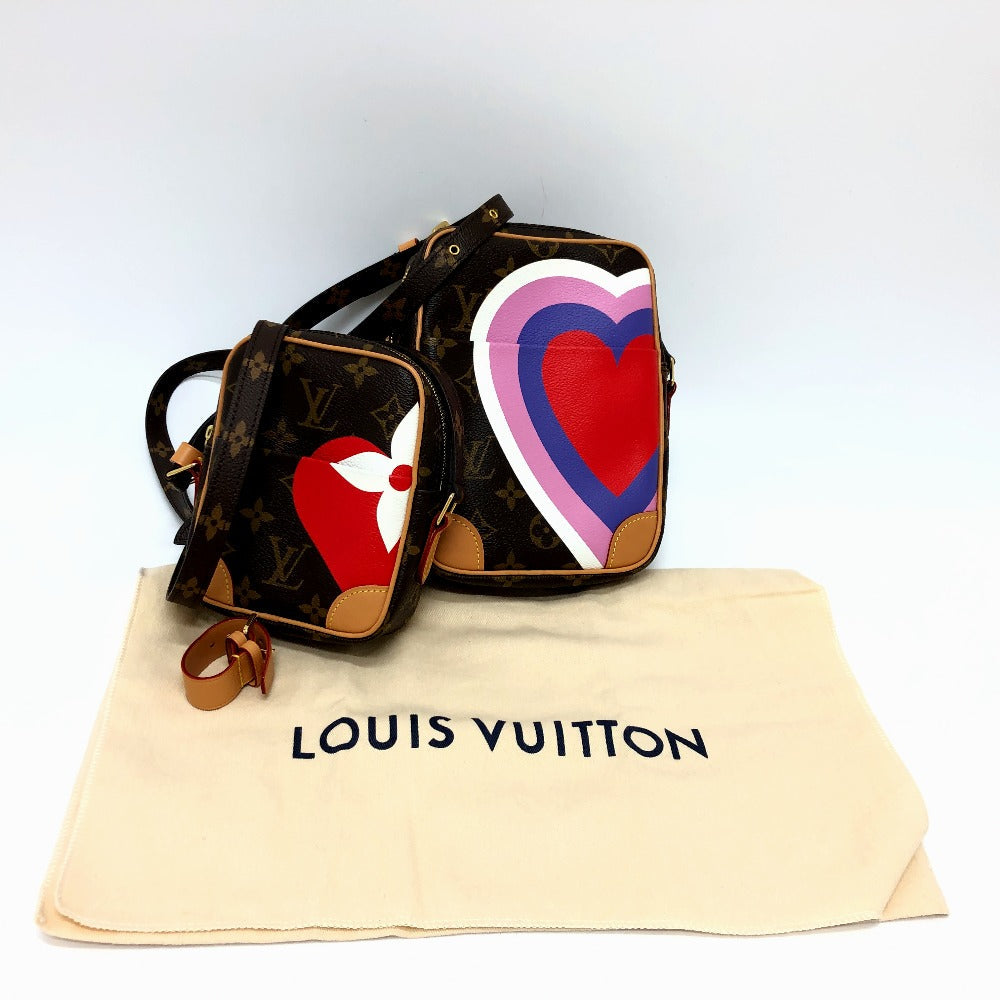 Louis Vuitton handbag with heart design on a white background