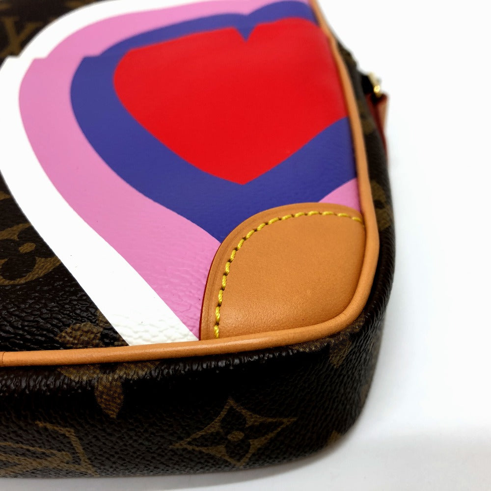 Designer handbag with a colorful heart-shaped card on a white background