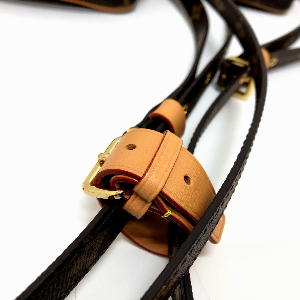 Close-up of a brown leather strap with gold buckle on a white background